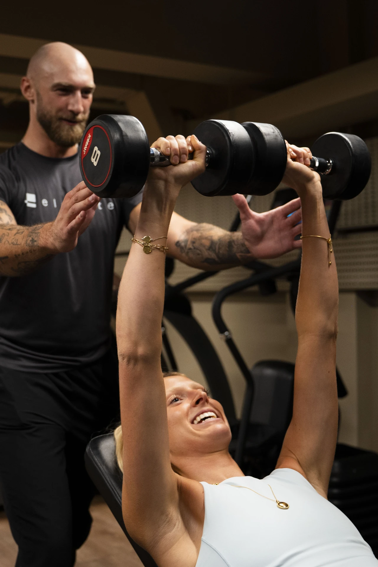 James Mansell spotting a client through a dumbbell press